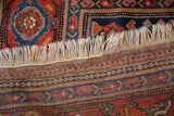 Detailed kilim end and secured ivory fringe of an antique Persian Hamadan rug.