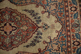 Low-pile texture showing the scalloped medallion and floral border of an antique Tabriz rug.