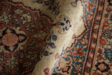 A soft fold in the antique Tabriz rug highlights its dense weave and low pile.