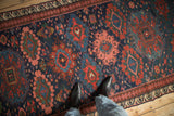 Personal perspective highlighting the scale of gul medallions on the antique Soumac runner.