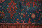 Detailed view of a hand-woven Soumac with ruby red and emerald green gul medallions.