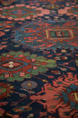 Rich field of gul medallions and blossoms on an antique Soumac runner in navy blue, ruby, and emerald.