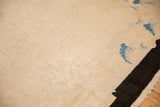 Even ivory pile on an antique Art Deco carpet, displaying subtle scrolled vines and black border.