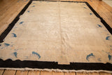 Natural fringe, charcoal black border, and subtle sapphire blue motifs on antique Art Deco carpet.