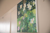 Angled view of the floral oil painting on canvas hanging as wall decor.