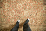 Distressed pile texture with dusty blush and ivory floral palmettes on a Vintage Mahal carpet.
