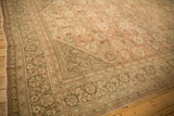 Distressed Mahal rug border with meandering vine and germinating plant motif, dusty blush field.