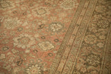 Distressed Mahal carpet: dusty blush floral palmettes transitioning to a vine border.