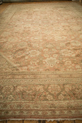 Distressed vintage Persian Mahal carpet detail, showing meandering vine border and faded florals.