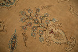 Vased Tree of Life motif with blue flowers and stylized birds on a sand-colored antique Yezd carpet.