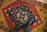 Floral and trident motifs in the sapphire blue medallion of an antique Anatolian rug.