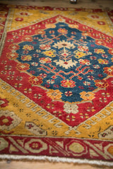 Hand-knotted texture and low pile of an antique Anatolian rug's sapphire blue medallion.