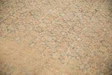 Detail of the even wear across the low pile of a vintage Tabriz in dusty teal and gold.