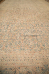 A low-angle view across the Tabriz carpet showing the even wear down to the knot heads.