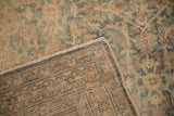 A folded corner reveals the dense hand-knotted weave on the back of a vintage Tabriz rug.