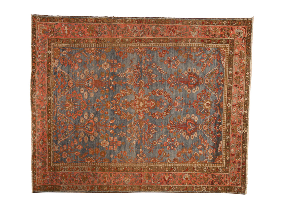 Vintage distressed Persian Mahal rug with floral tree-of-life designs over an abrashed blue field.