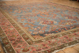 Perspective view of the vintage Mahal's distressed texture and intricate palmette border.