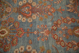 Germinating tree of life and floral blossoms in pink and bronze on an abrashed blue field.