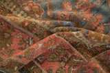 Worn, low-pile texture of the Persian Mahal's floral border in shades of pink and bronze.