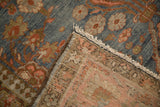 The hand-knotted back and distressed pile of a vintage Persian Mahal carpet corner.