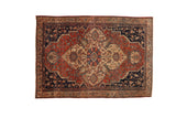 Vintage Farahan Sarouk rug with a shield medallion and intricate florals in madder red, navy blue, and ivory.