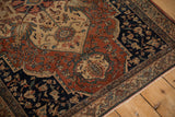 Angled view of the intricate turtle samovar border and medallion on a vintage Farahan Sarouk.