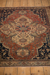 A long perspective view of the vintage Farahan Sarouk rug, showcasing its intricate shield medallion.
