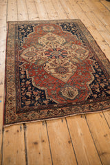 Angled view of a traditional Farahan Sarouk rug, showing its full length and complex medallion design.