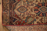 Intricate turtle samovar border motif and restored red selvage at the corner of a vintage rug.