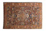 Vintage Farahan Sarouk rug with a central medallion and scrolling florals in copper and sand on a navy blue ground.