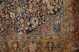 Intricate scrolling vine field and copper-toned floral border on a vintage Persian Sarouk rug.