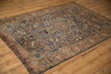 Angled view of a vintage Farahan Sarouk rug's traditional scrolling vine and medallion design.