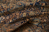 Low pile of a vintage Farahan Sarouk rug with bronze and navy scrolling floral motifs.