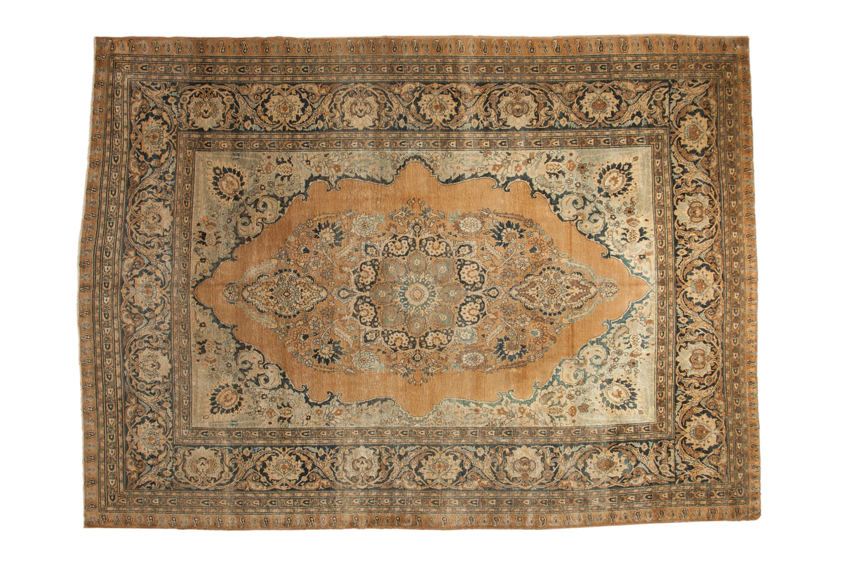 Antique Haji Jalili Tabriz carpet with a roundel medallion, floral arabesques in camel, blue, and ivory, size 8'8" x 12'.