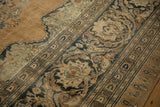 Detail of Rococo arabesques and floral palmettes on an antique tea-washed Tabriz carpet.