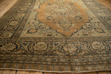 Intricate borders and grand medallion of an antique Haji Jalili Tabriz carpet from a low angle.