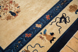 Detailed view of the cobalt blue border with floral sprigs on an antique Peking carpet.