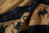A close view of the antique Peking carpet's soft, even pile and dark blue design details.
