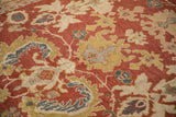 Expressive floral cross sections and serrated leaves on the low pile of an antique Mahal carpet.