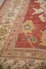 Angled view showing the knot heads and turtle samovar border on an antique Persian rug.