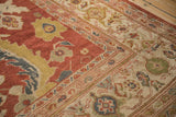 Corner detail of an antique Mahal carpet showing the ivory turtle samovar border and madder red floral field.