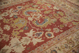 Expressive rendering of sprawling serrated leaves and florals on an antique Mahal carpet.