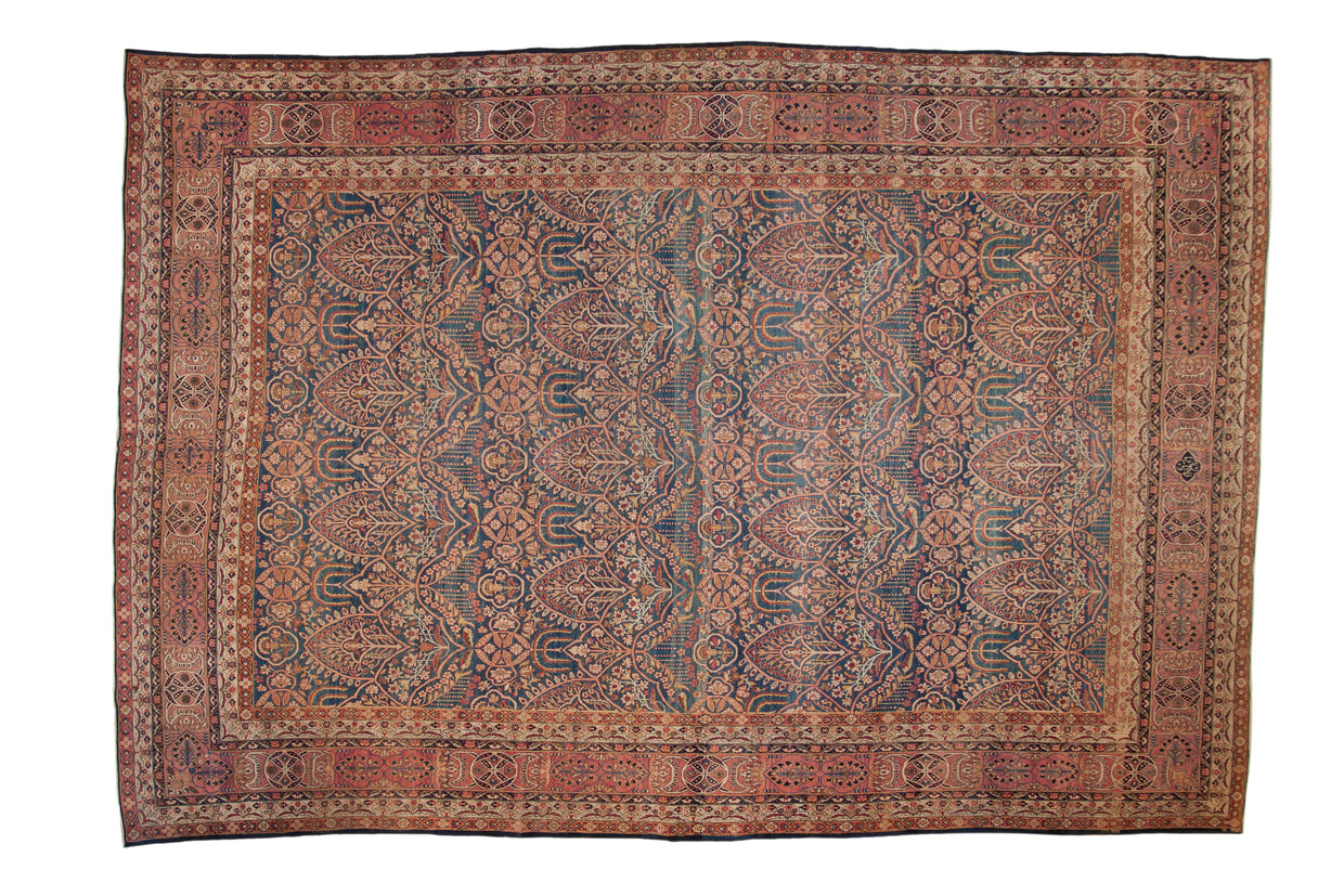 Antique fine Kerman carpet with an allover design of floral trefoil panels in navy blue, dusty blush, and ivory.
