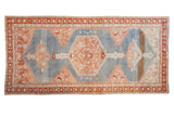 Antique Karabagh runner with a large hexagonal medallion in red and blush on a distressed powder blue field.
