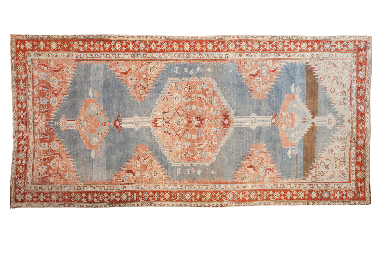 Antique Karabagh runner with a large hexagonal medallion in red and blush on a distressed powder blue field.