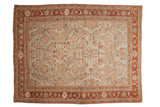A distressed vintage Mahal carpet with an allover floral pattern in terracotta and beige over a soft, powder blue field.