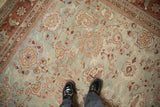 Distressed low pile of a vintage Mahal carpet with floral palmettes in jade green and dusty rose.