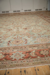 Low perspective view of a distressed Mahal carpet's worn pile, terra cotta border, and jade field.