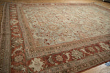 A close view showing the time-softened low pile and intricate palmette designs of a vintage Mahal carpet.