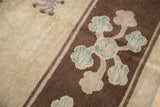 Sapphire blue and mauve blossomed flower bouquet on the antique carpet's dark brown border.